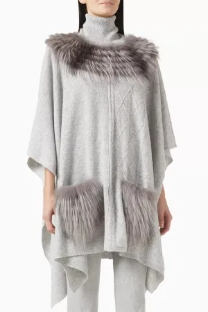 CABLE KNIT PONCHO WITH FUR NECKLINE AND POCKETS IN FOG